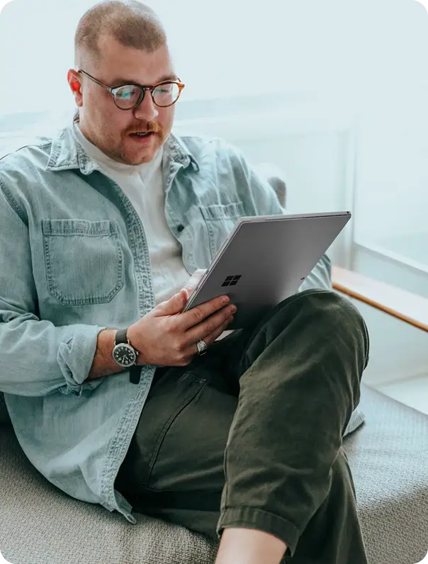 Man with glasses looking at Mtg Broker app on tablet
