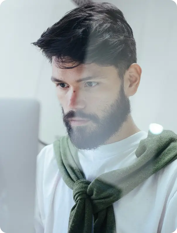 young man in front of computer on Mtg Broker app